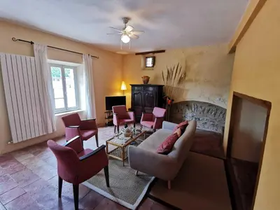 a living room with a couch and chairs at La maison du berger in Cassagnes