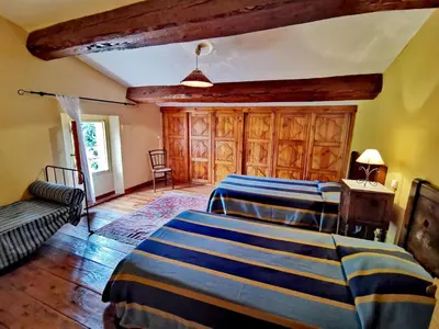 a bedroom with two beds in a room at La maison du berger in Cassagnes