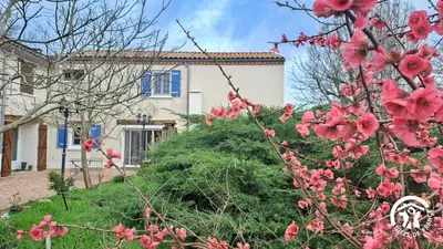 a house with pink flowers in front of it at L'esquirou in Castres