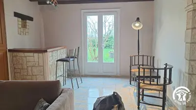 a living room with a couch and chairs and a door at L'esquirou in Castres