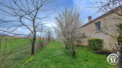 a house with a fence and trees in the yard at L'esquirou in Castres