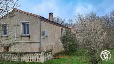 an old house with a fence in front of it at L'esquirou in Castres
