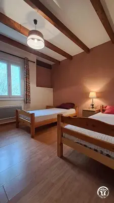 a bedroom with two beds and a window at L'esquirou in Castres