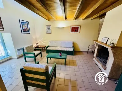 a living room with a couch and a fireplace at La marelle in Villerouge-Termenès