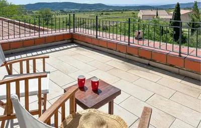 a patio with two red glasses on a table at Amazing Home In Cazelles, Agel in Agel