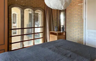 a bedroom with a bed and a large window at Amazing Home In Cazelles, Agel in Agel