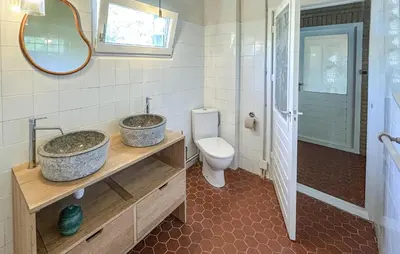 a bathroom with two sinks and a toilet at Amazing Home In Cazelles, Agel in Agel
