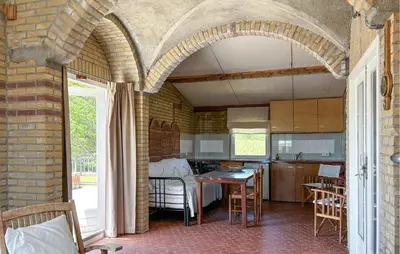 an archway in a kitchen with a table and chairs at Amazing Home In Cazelles, Agel in Agel