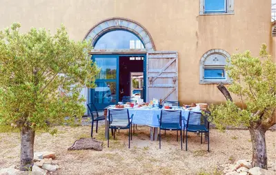 a table with chairs and a blue table cloth at Amazing Home In Cazelles, Agel in Agel