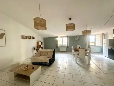 a living room with a couch and a table at Cosy Appartement 45 m2 en cœur de ville, proche gare in Narbonne