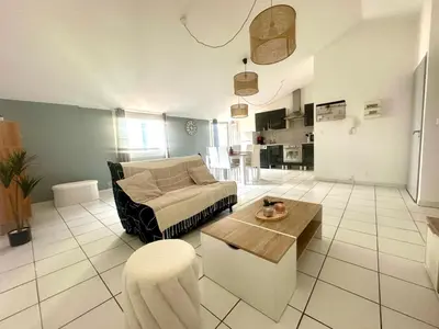 a living room with a couch and a table at Cosy Appartement 45 m2 en cœur de ville, proche gare in Narbonne
