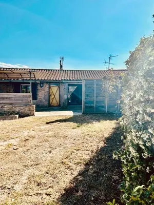 a house with a barn with its door open at Grande maison de charme près de Carcassonne avec terrasse et jardin in Palaja