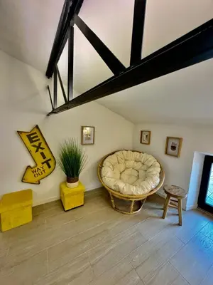 a living room with a large couch and a table at Grande maison de charme près de Carcassonne avec terrasse et jardin in Palaja
