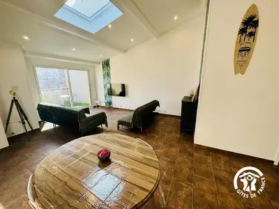 a living room with a table and a couch at Gite de l'avenue in Sigean