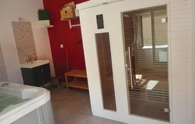 a bathroom with a large glass shower in a room at Nice Home In Narbonne With Sauna in Narbonne