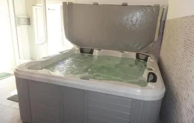 a bath tub filled with green water in a bathroom at Nice Home In Narbonne With Sauna in Narbonne