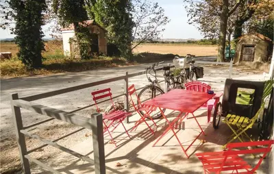 a table and chairs and bikes parked on the side of a road at Nice Home In Narbonne With Sauna in Narbonne