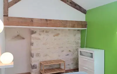 a room with a green accent wall and a tv at Nice Home In Narbonne With Sauna in Narbonne