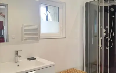 a white bathroom with a sink and a shower at Nice Home In Narbonne With Sauna in Narbonne