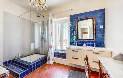 a bathroom with a tub and a sink and a mirror at Awesome Home In Capendu in Capendu