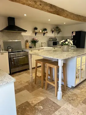 a kitchen with a large island in a kitchen at Charmante ferme familiale in Guitalens