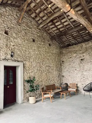 a room with benches and a brick wall at Charmante ferme familiale in Guitalens