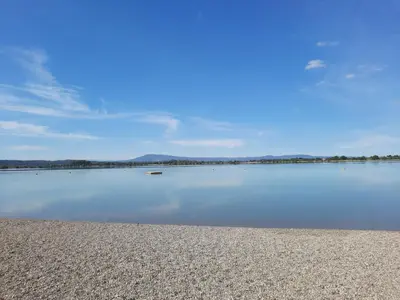 a large body of water with mountains in the background at Opuntia Teouliero location en Méditerranée in Escales
