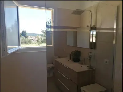 a white bathroom with a sink and a window at Suite parentale avec terrasse solarium in Saint-André-de-Roquelongue
