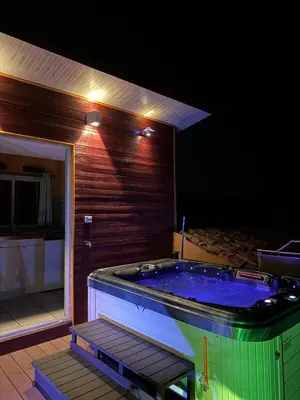 a jacuzzi tub in the middle of a house at Maison de village avec spa privé & grande terrasse calme & détente in Dourgne