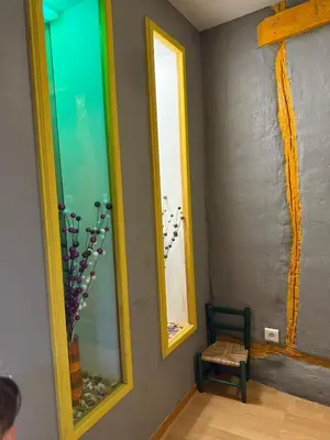 a room with two mirrors and a chair at Maison de village avec spa privé & grande terrasse calme & détente in Dourgne