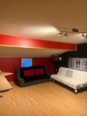 a room with two beds and a red wall at Maison de village avec spa privé & grande terrasse calme & détente in Dourgne