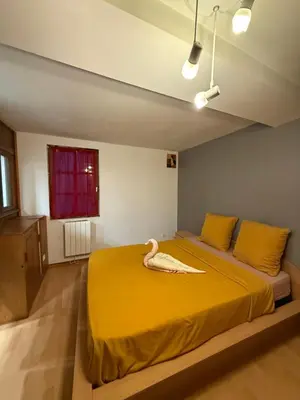 a large kitchen with a table and chairs in it at Maison de village avec spa privé & grande terrasse calme & détente in Dourgne