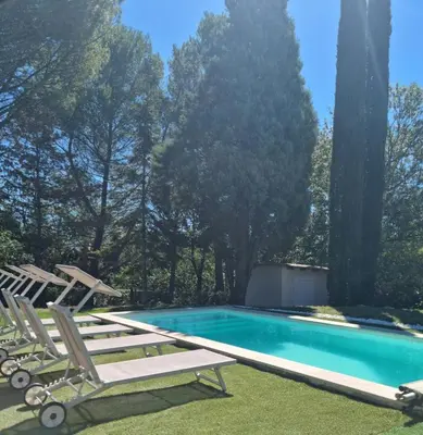 a swimming pool with two lounge chairs and a swimming pool at Aux couleurs de la terre d'oc in Villepinte