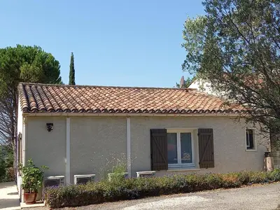 a small house with a window on a street at Aux couleurs de la terre d'oc in Villepinte