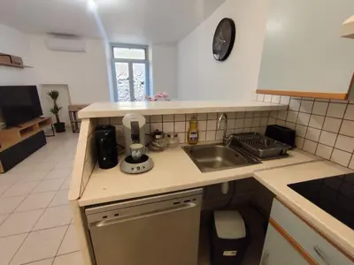 a kitchen with a sink and a counter top at Escale au pied de la cité in Carcassonne