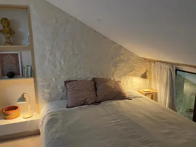 a bed with two pillows on it in a bedroom at Chambres d'hôtes -L'Atelier du Presbytère