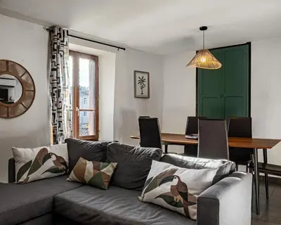 a living room with a couch and a table at La Glycine in Montolieu