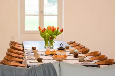 a table with flowers and bowls of food on it at Le domaine de rigou in Lasbordes