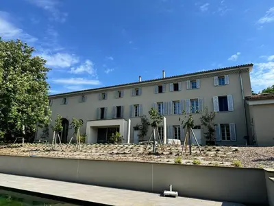 a large white building with trees in front of it at Le domaine de rigou in Lasbordes