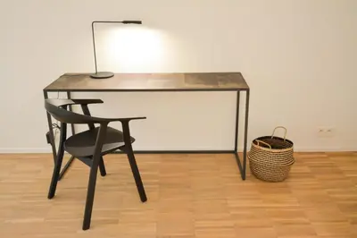 a black desk with a chair and a basket at Le domaine de rigou in Lasbordes