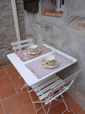 a white table with two cups and plates on it at Maison Au Phil de Lau in Raissac-dʼAude