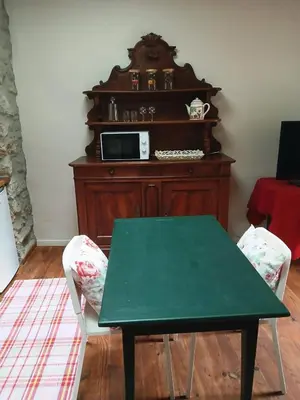 a green table and two chairs in a room at Maison Au Phil de Lau in Raissac-dʼAude
