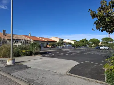 an empty parking lot with a car parked in it at Appartement T2 entre mer et lac in Port-la-Nouvelle