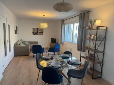 a living room with a table and chairs at Appartement centre ville Sigean in Sigean