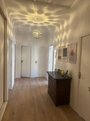 an empty room with a table and a chandelier at Appartement centre ville Sigean in Sigean