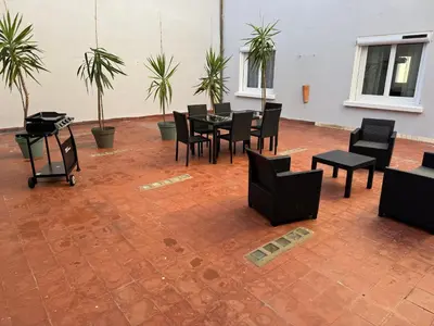 a patio with a table and chairs and plants at Appartement centre ville Sigean in Sigean
