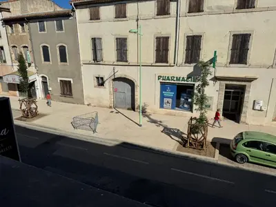 a green car parked in front of a building at Appartement centre ville Sigean in Sigean