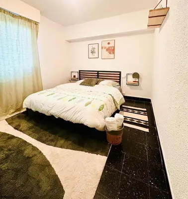 a bedroom with a bed and a window at Les Fleurs de la Cité - T3 Parking privé et Terrasse Jardin Privé in Carcassonne