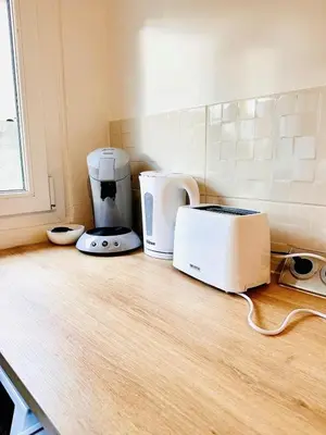 a kitchen counter with a toaster and a toaster at Les Fleurs de la Cité - T3 Parking privé et Terrasse Jardin Privé in Carcassonne