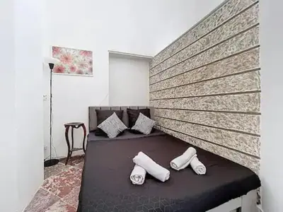 a bedroom with a bed with two white pillows at Charmant T2 Narbonne centre in Narbonne